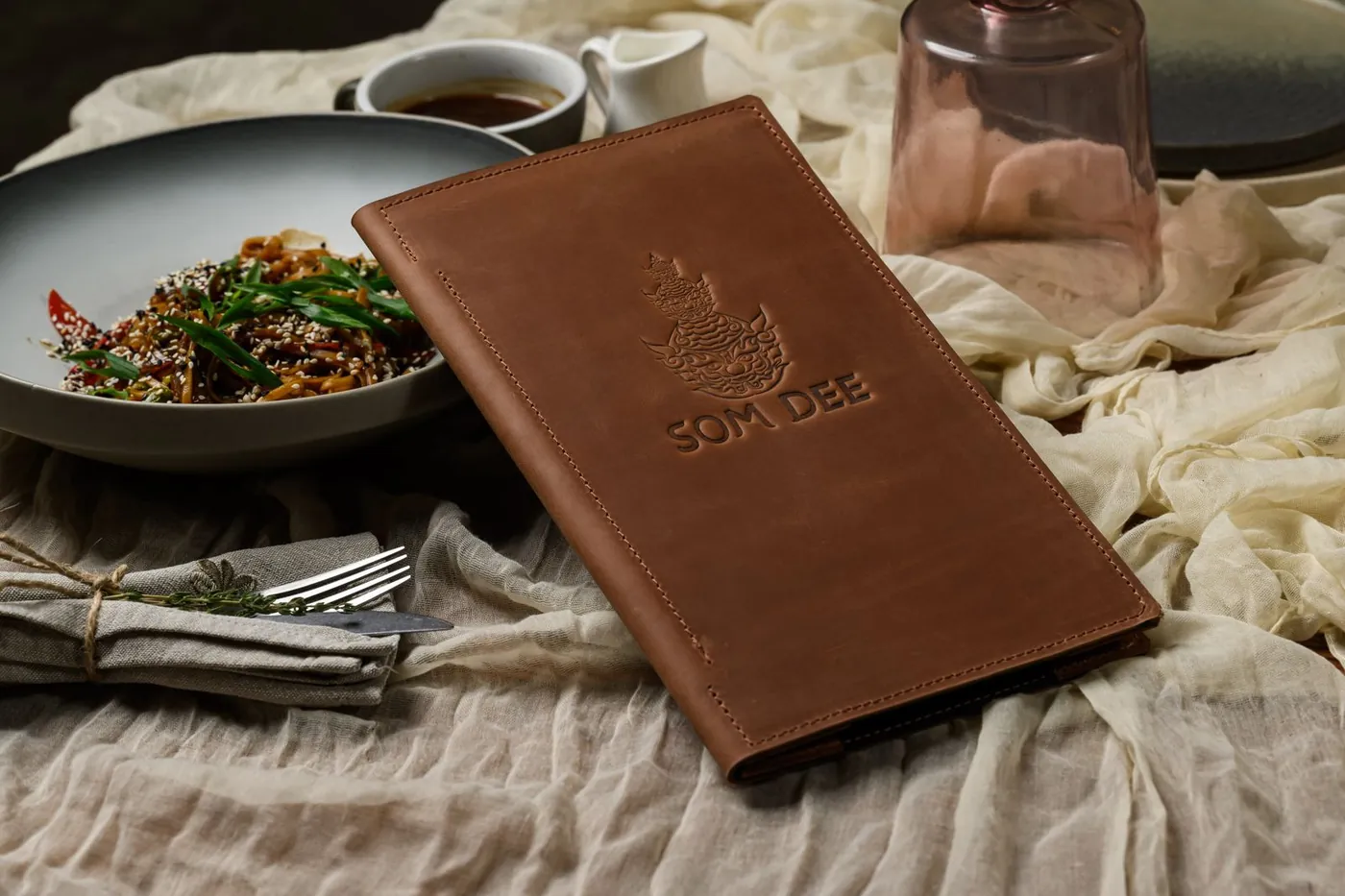 Brown leather menu cover · embossed logo