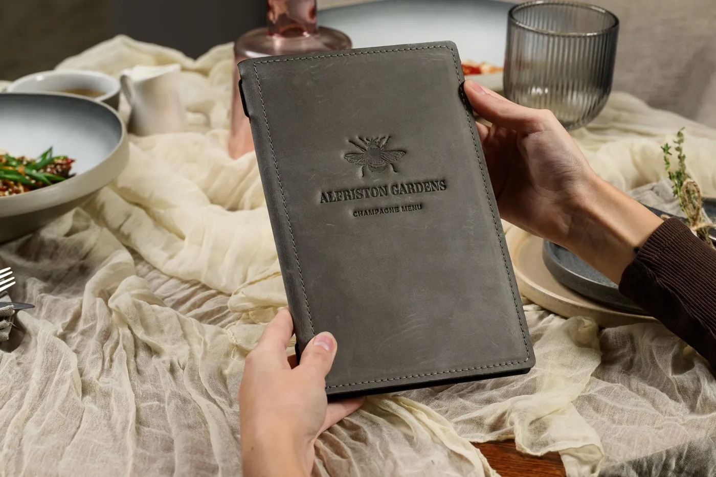 Grey nubuck menu cover · embossed logo